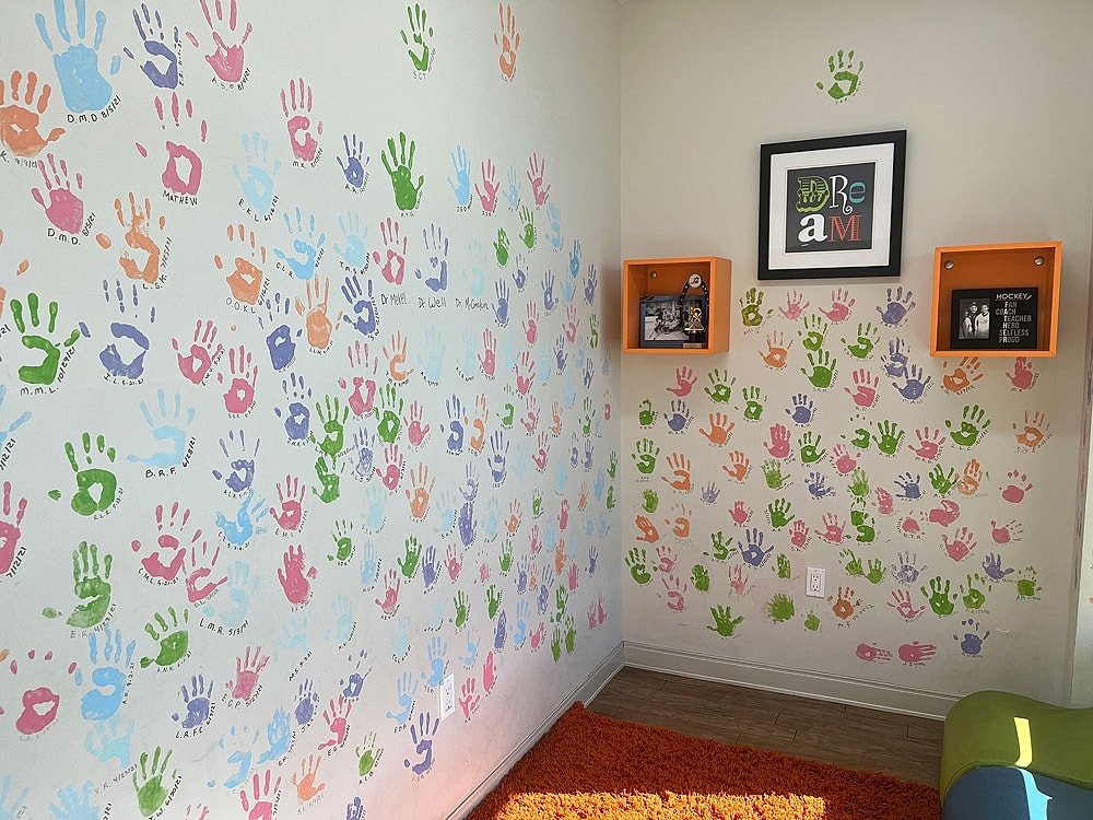 Colorful handprints on a playful children's wall.