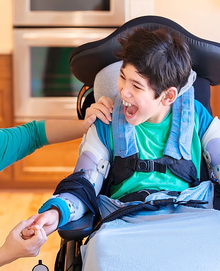 Smiling boy with backpack in outdoor setting.
