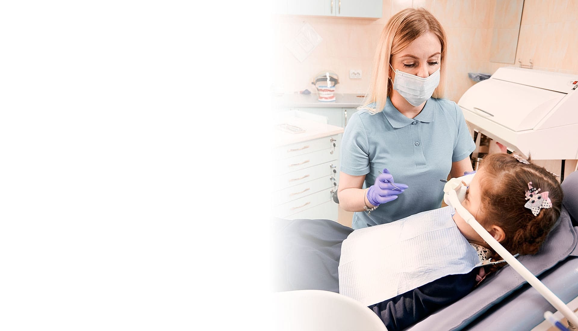Dentist examining young girl in a dental office.